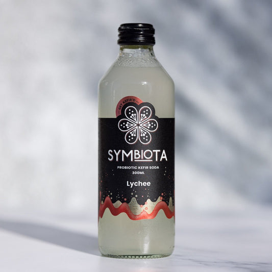 bottle of lychee kefir soda by symbiota