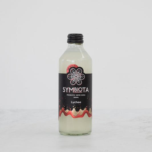 bottle of lychee probiotic kefir soda by symbiota